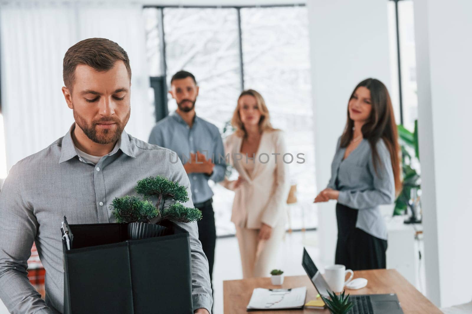 Holding package in hands. Group of business people that working on the project in the office.