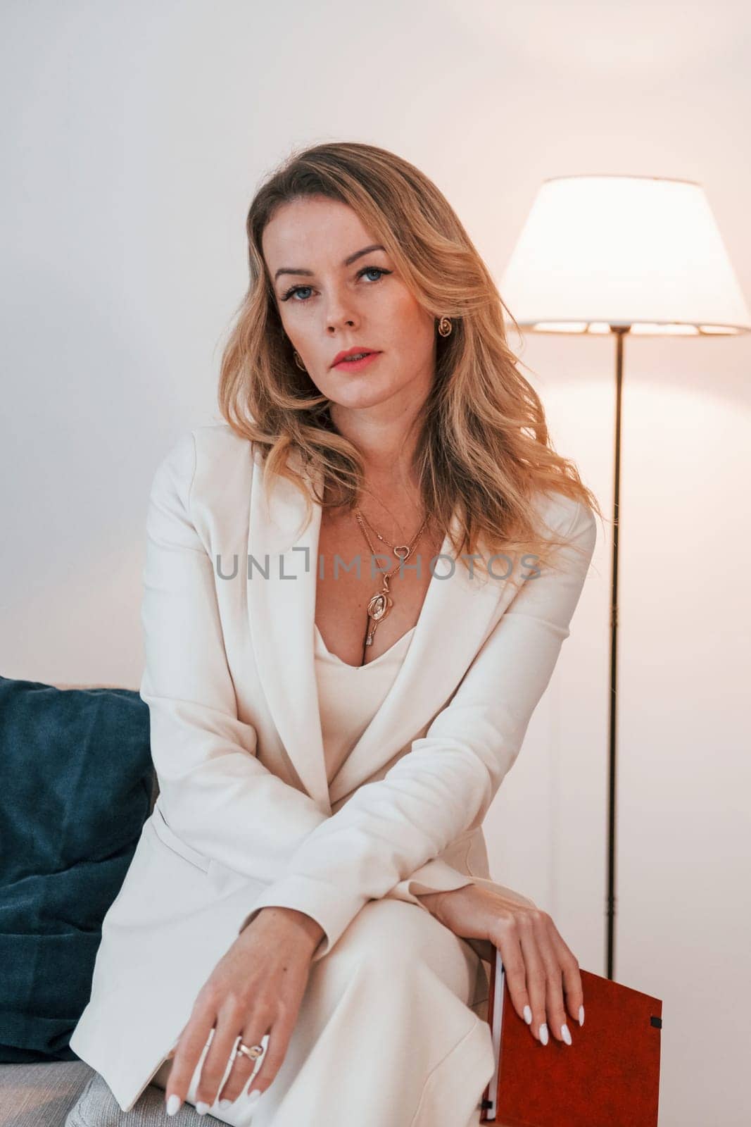 Business woman in formal clothes is indoors posing for the camera.