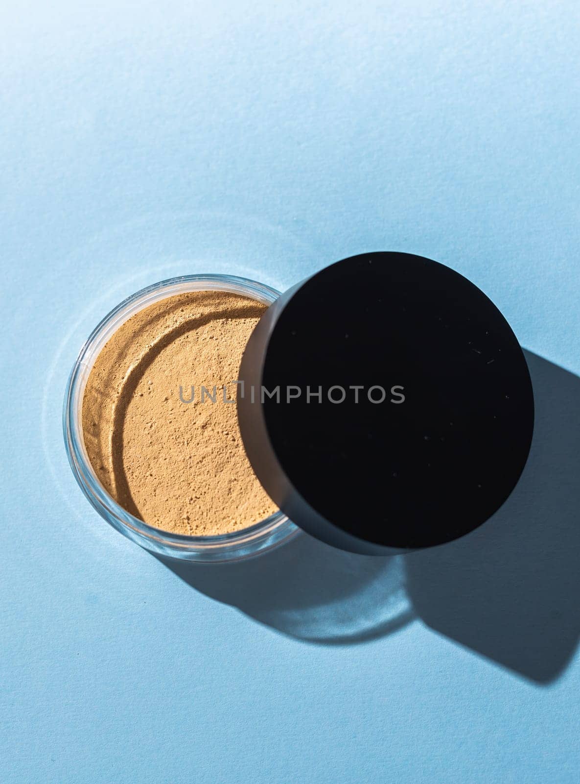 Mineral powder foundation isolated on blue background. Eco-friendly and organic beauty products by Satura86