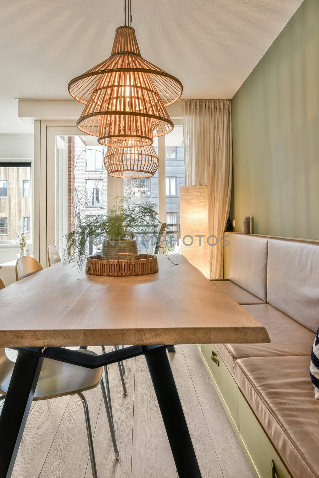 a dining room with a large wooden table and chairs by casamedia