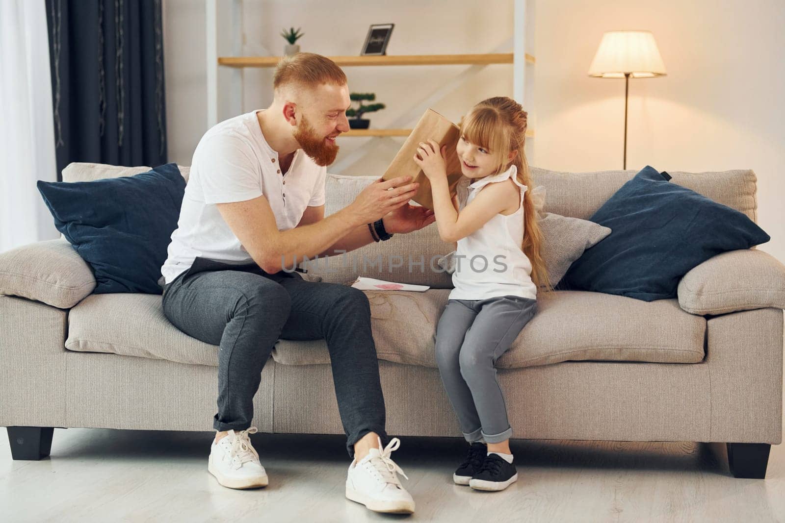 Father with his little daughter is at home together.