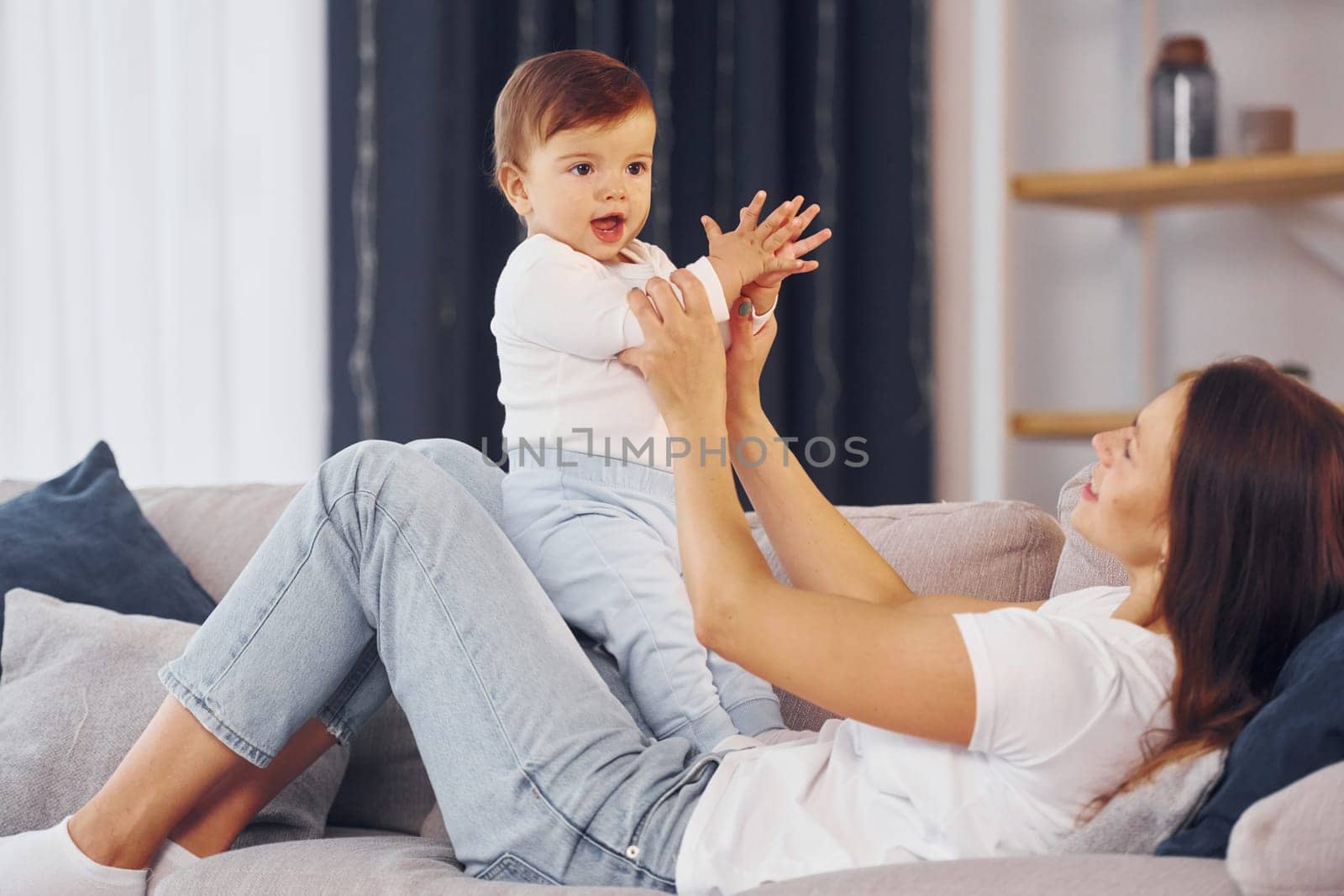 Mother with her little daughter is at home together.