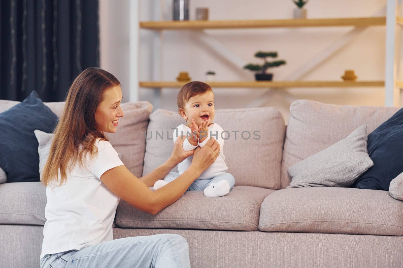 Mother with her little daughter is at home together.