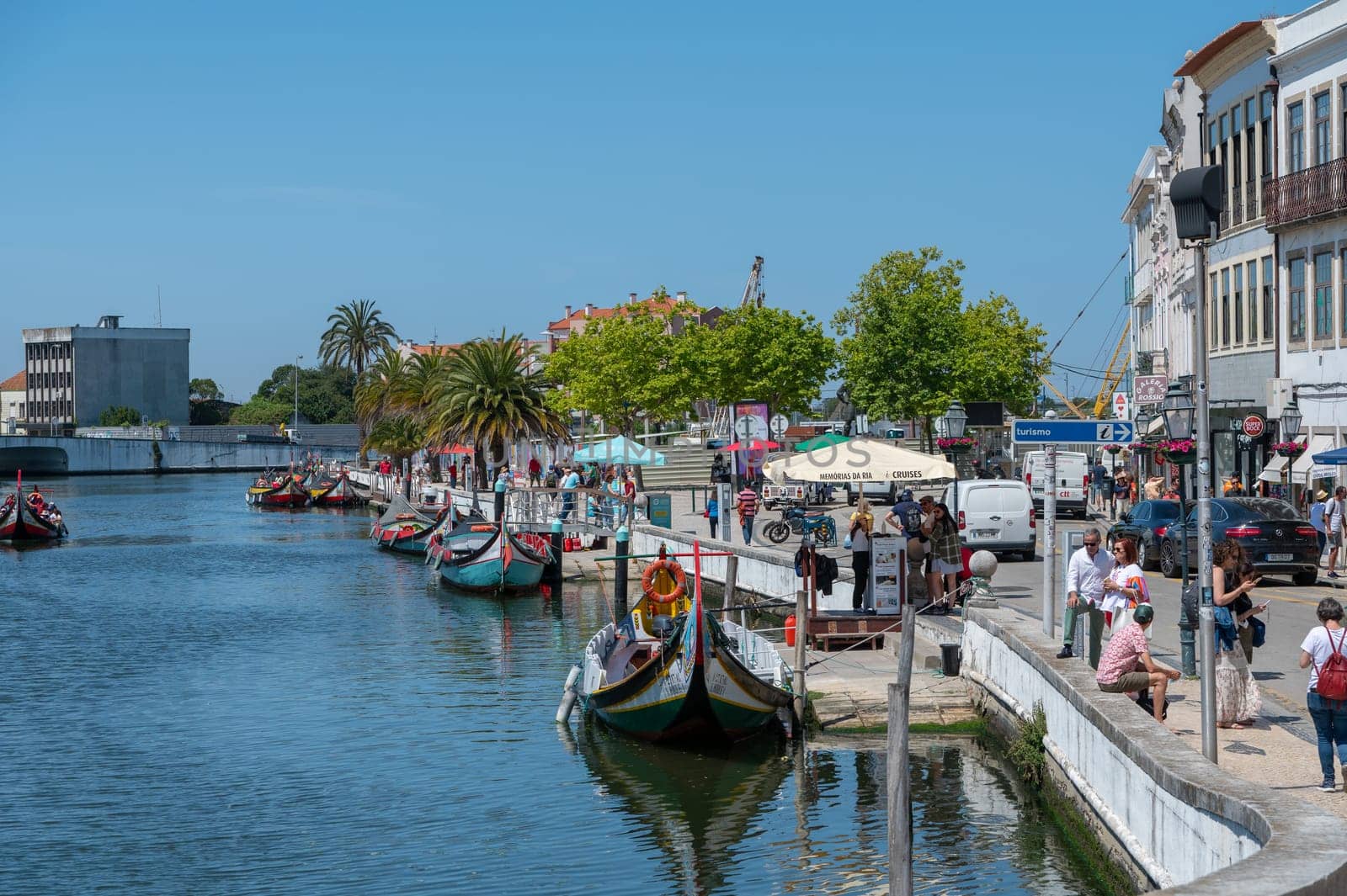 Traditional boats in the canal of Aveiro, Portugal. The colorful Moliceiro de Aveiro boat tours are popular with tourists to enjoy views of the charming canals. Aveiro, Portugal. by martinscphoto