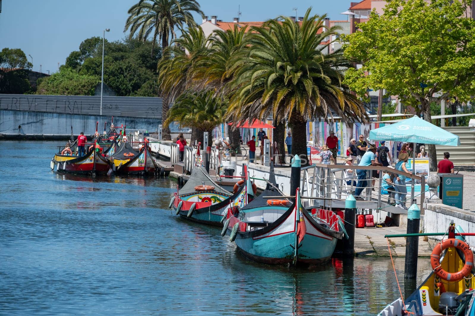 Traditional boats in the canal of Aveiro, Portugal. The colorful Moliceiro de Aveiro boat tours are popular with tourists to enjoy views of the charming canals. Aveiro, Portugal. by martinscphoto