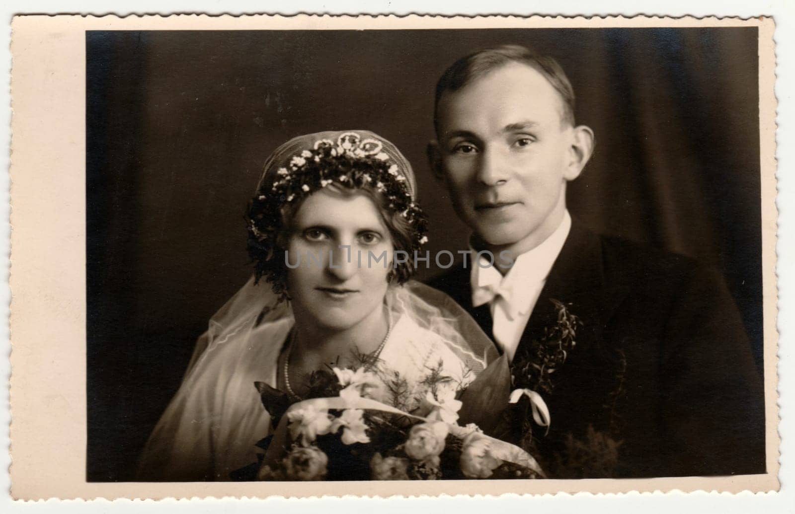 Vintage photo shows newlyweds. Bride wears tiara. Retro black and white photography. Circa 1950s. by roman_nerud
