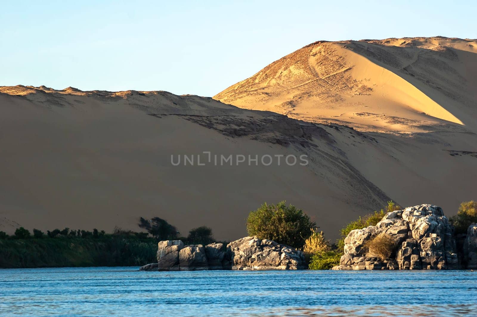 Abu Simbel, Aswan, Egypt - April 18 2008: the river Nile and the sand dunes in the background