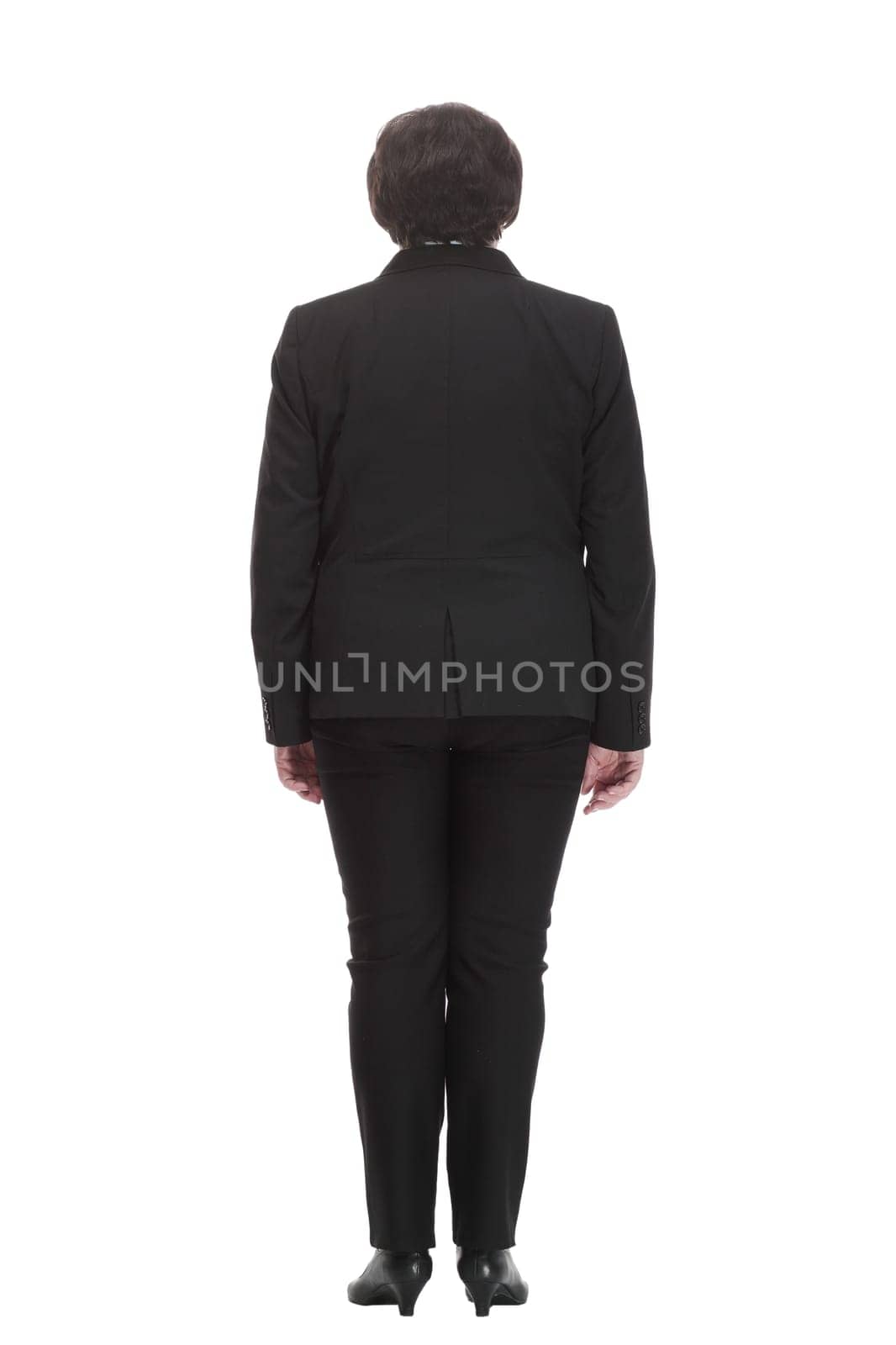 rear view. Mature business woman in a black pantsuit . isolated on a white background.