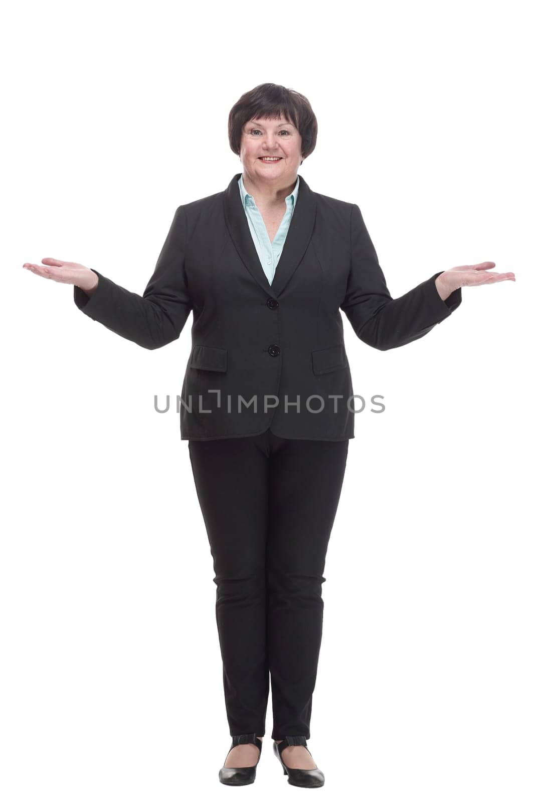in full growth.Mature business woman in a pantsuit . isolated on a white background.