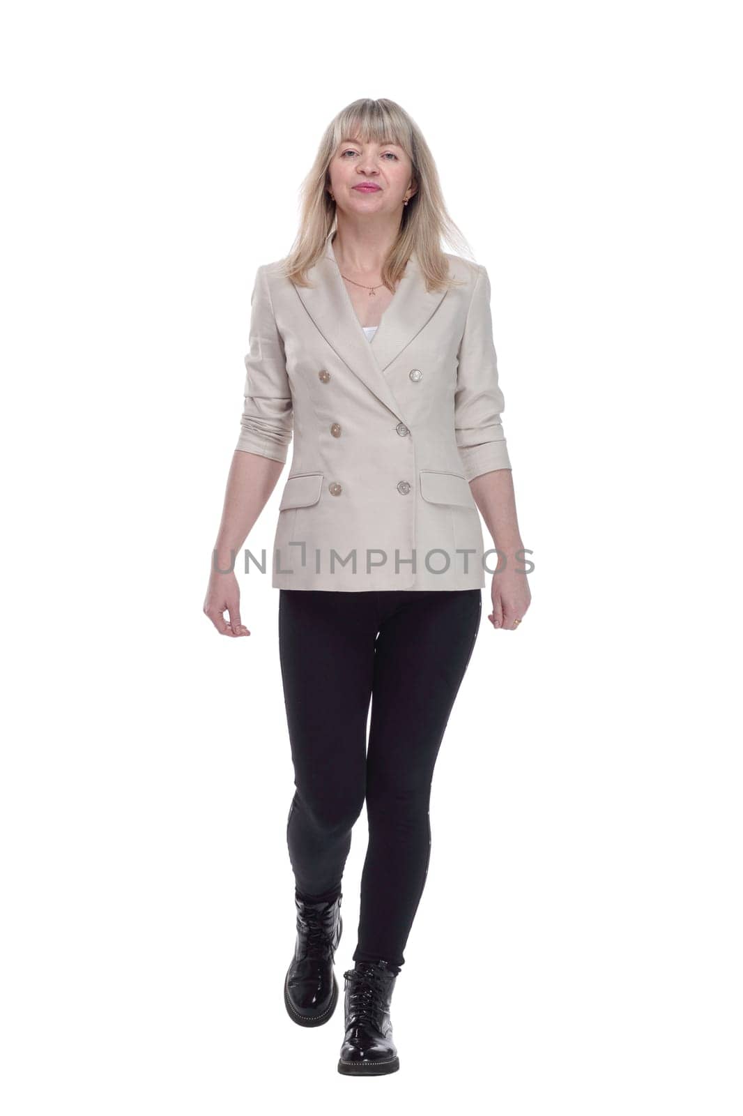 full-length. casual woman in a white jacket striding forward. isolated on a white background.