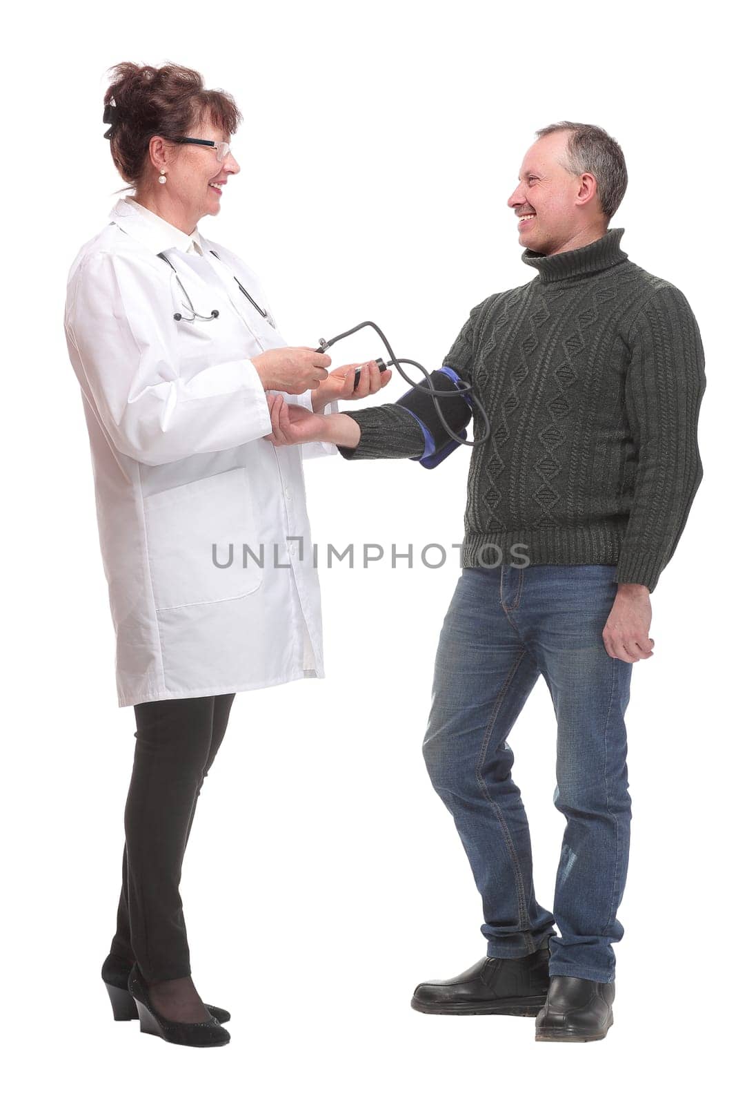 Senior smiling cheerful female medicine doctor measuring blood pressure to patient by asdf