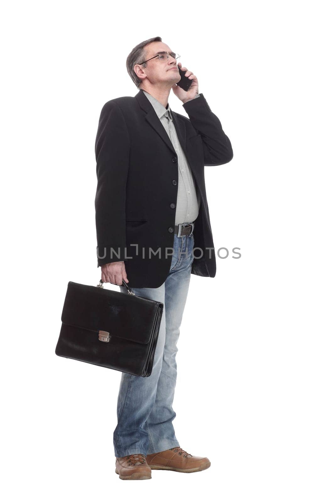 in full growth. serious business man with a smartphone. isolated on a white background.