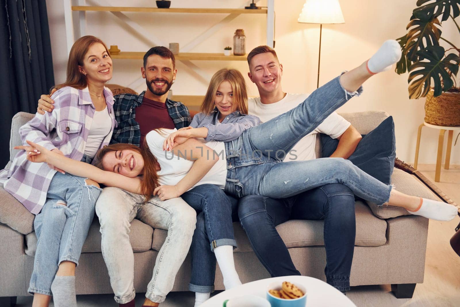 Group of friends have party indoors together.