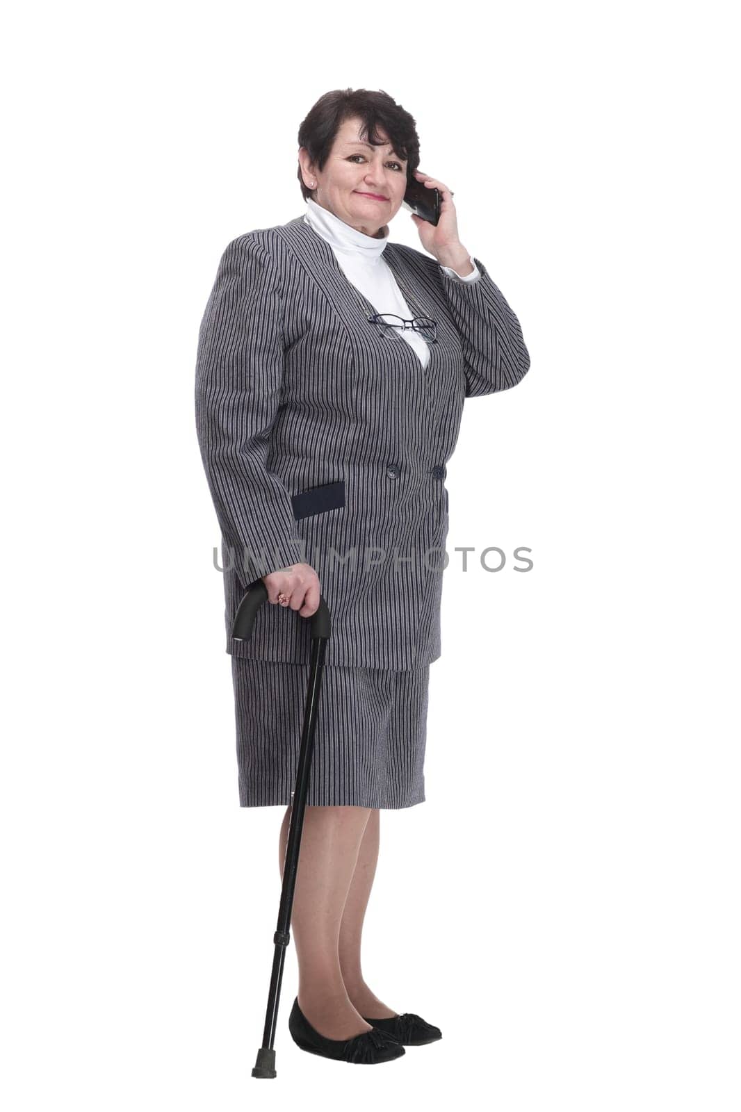 in full growth. casual elderly woman with a mobile phone. isolated on a white background.