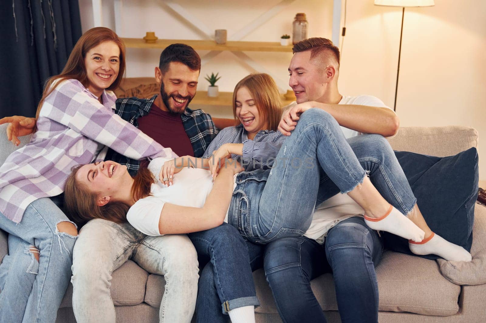 Group of friends have party indoors together.