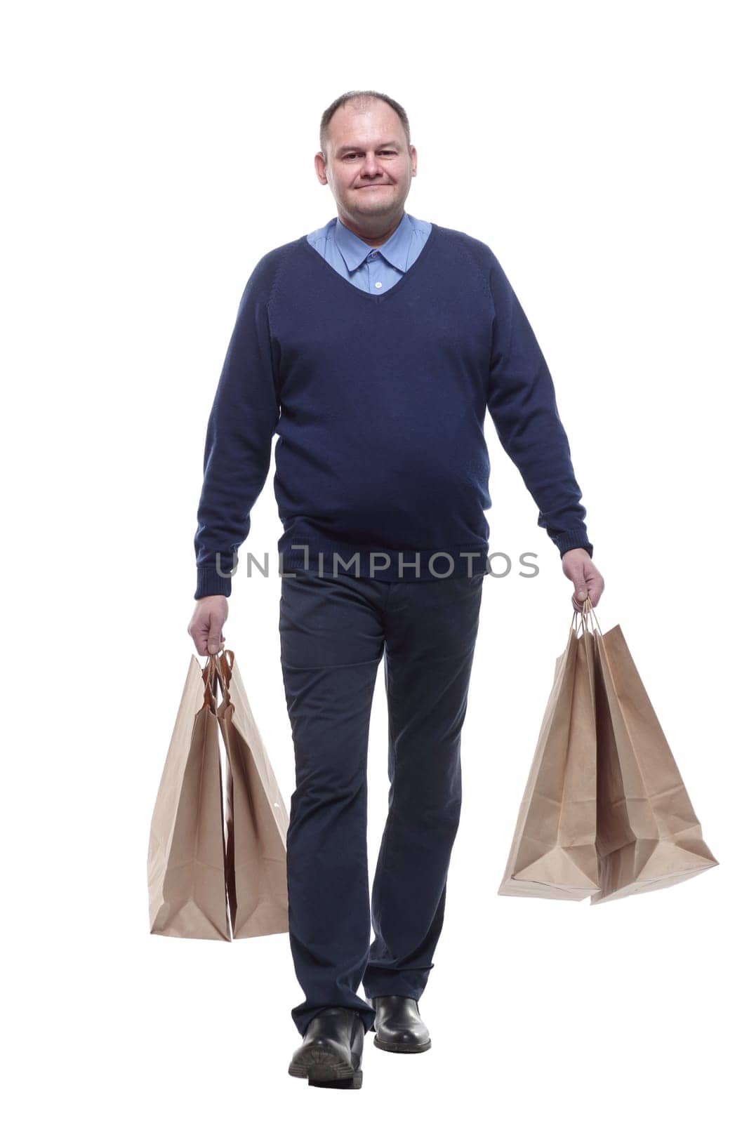 in full growth. casual mature man with shopping bags. isolated on a white background.