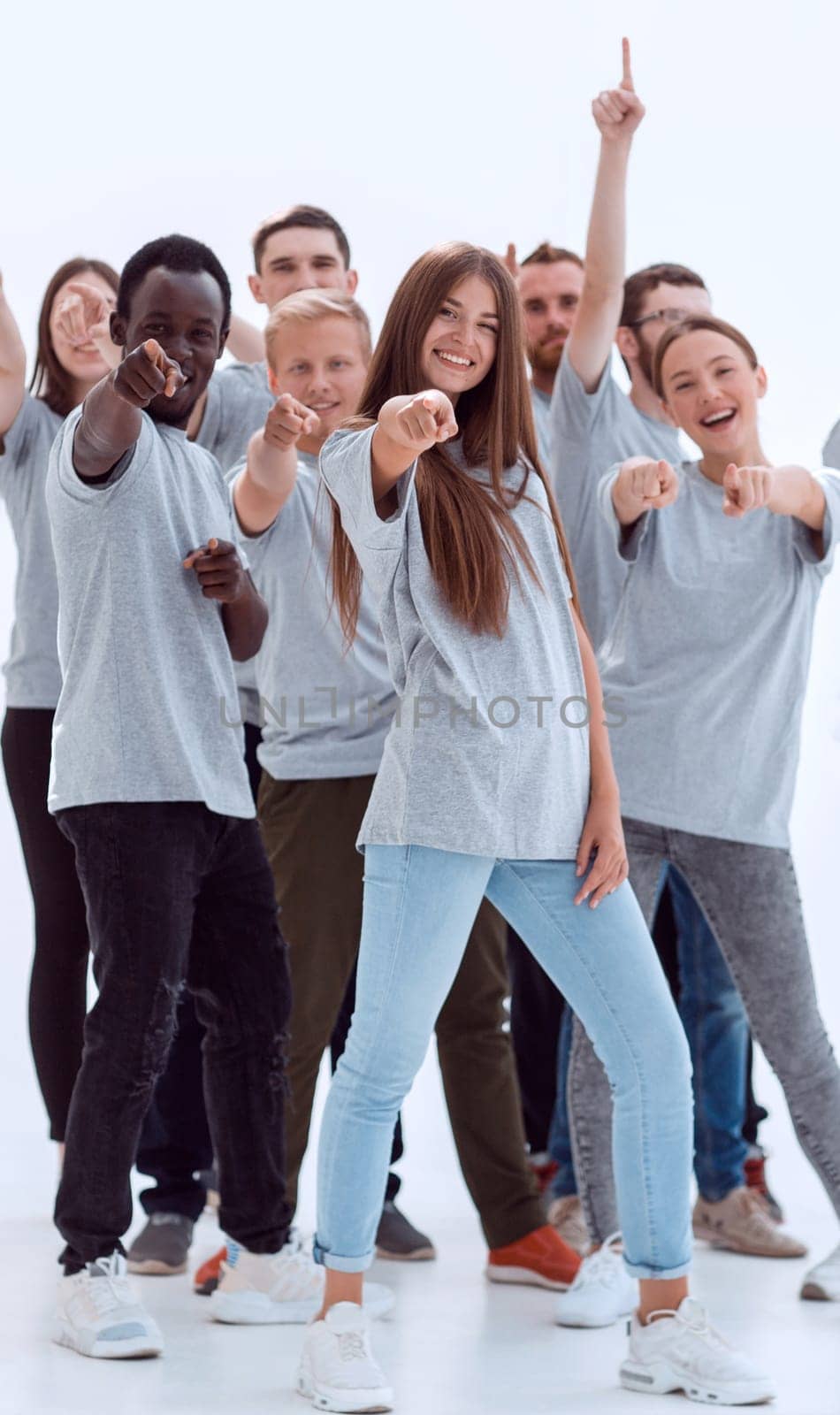 group of happy young people pointing somewhere up. isolated on white