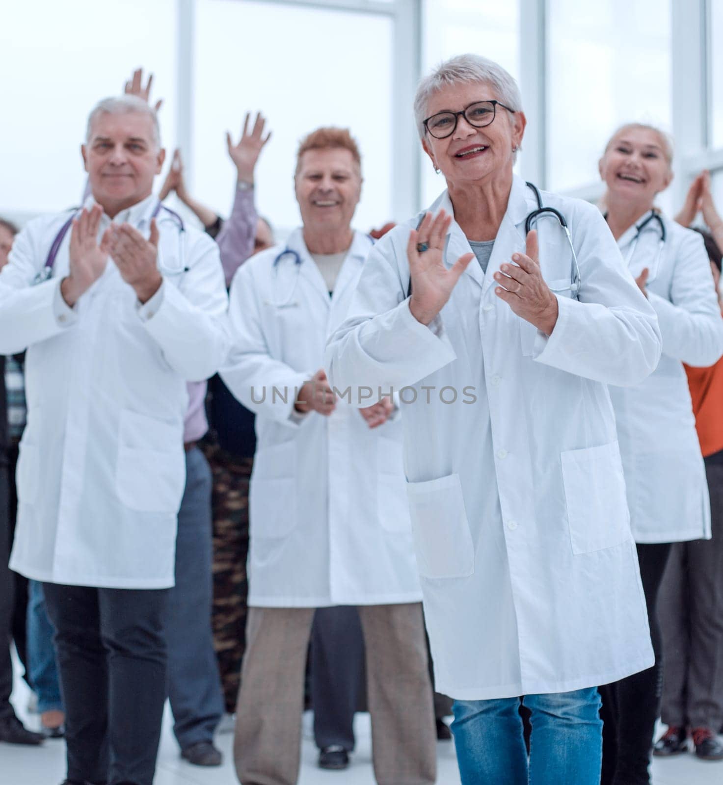 doctors and patients clap their hands.
