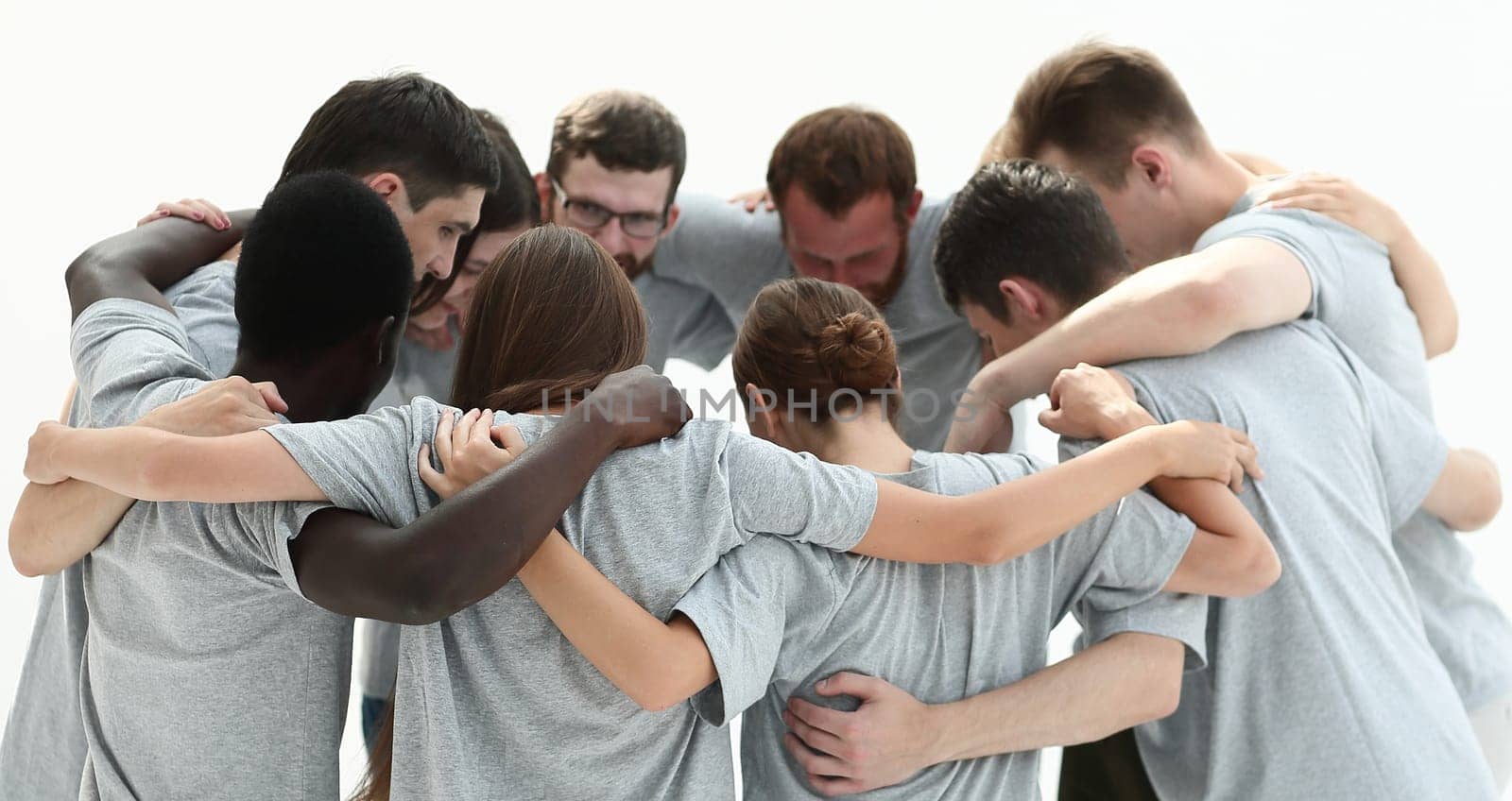 group of young people standing in a circle and hugging each other. isolated on white