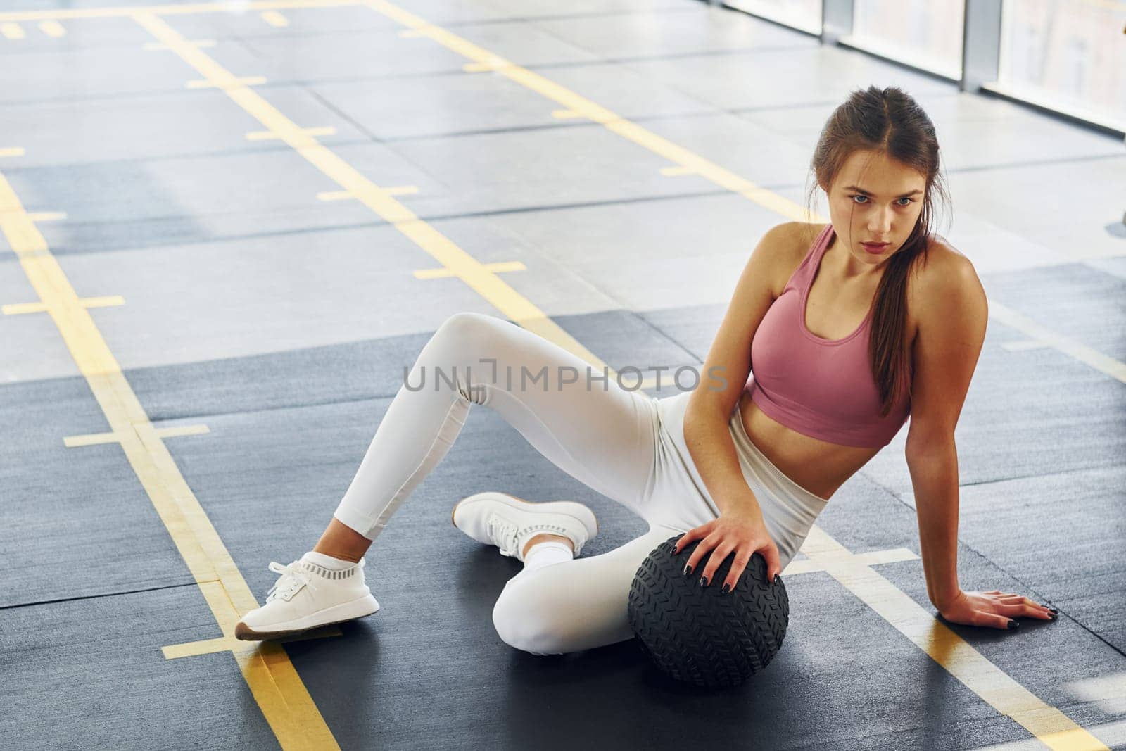 Tired beautiful young woman with slim body type is in the gym.