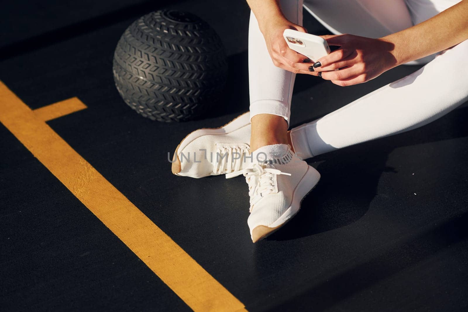 Tired beautiful young woman with slim body type is in the gym.