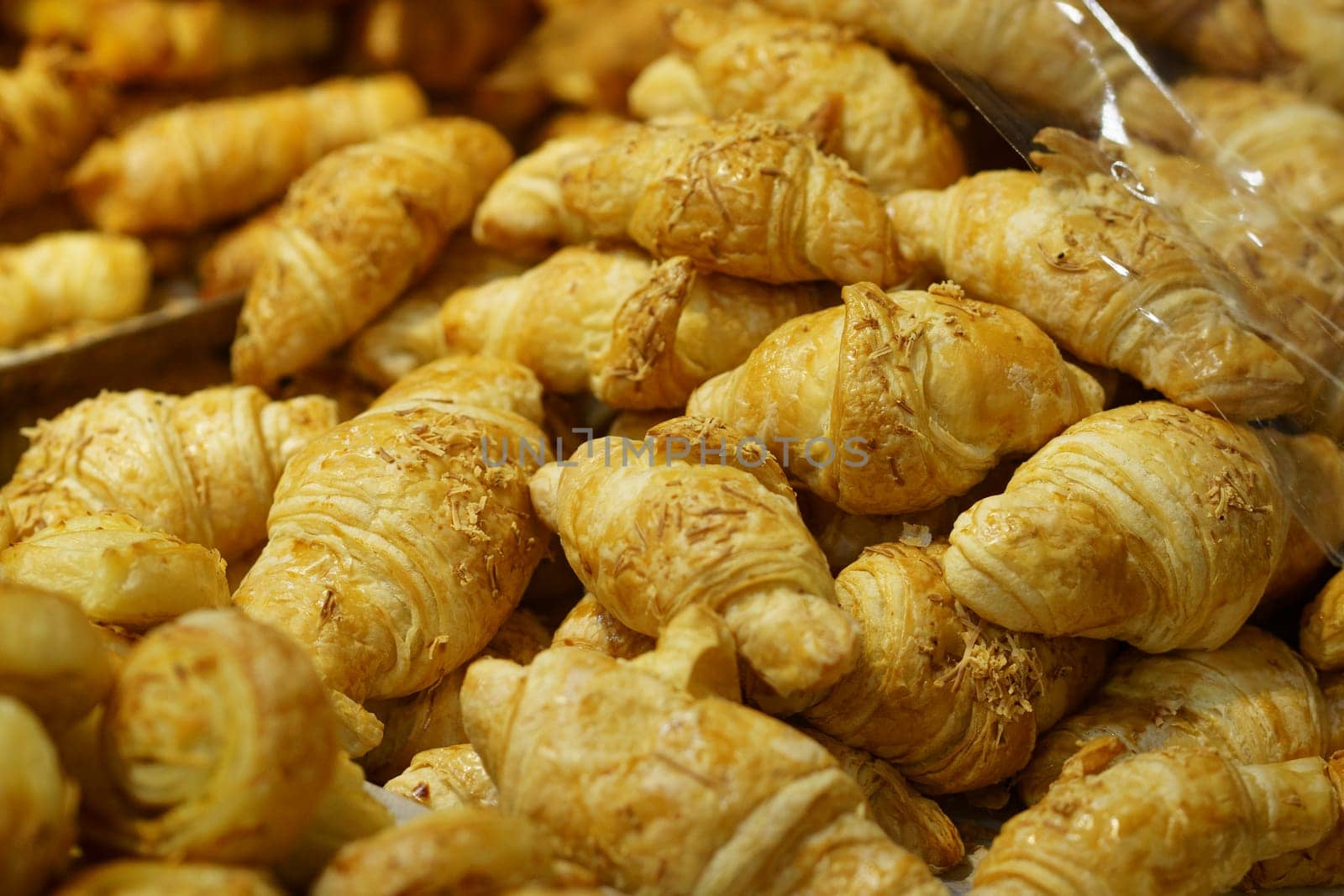Sale of Cheese croissants and other pastries on the counter in the Supermarket in Surabaya, Indonesia. Selectieve focus and defocused.