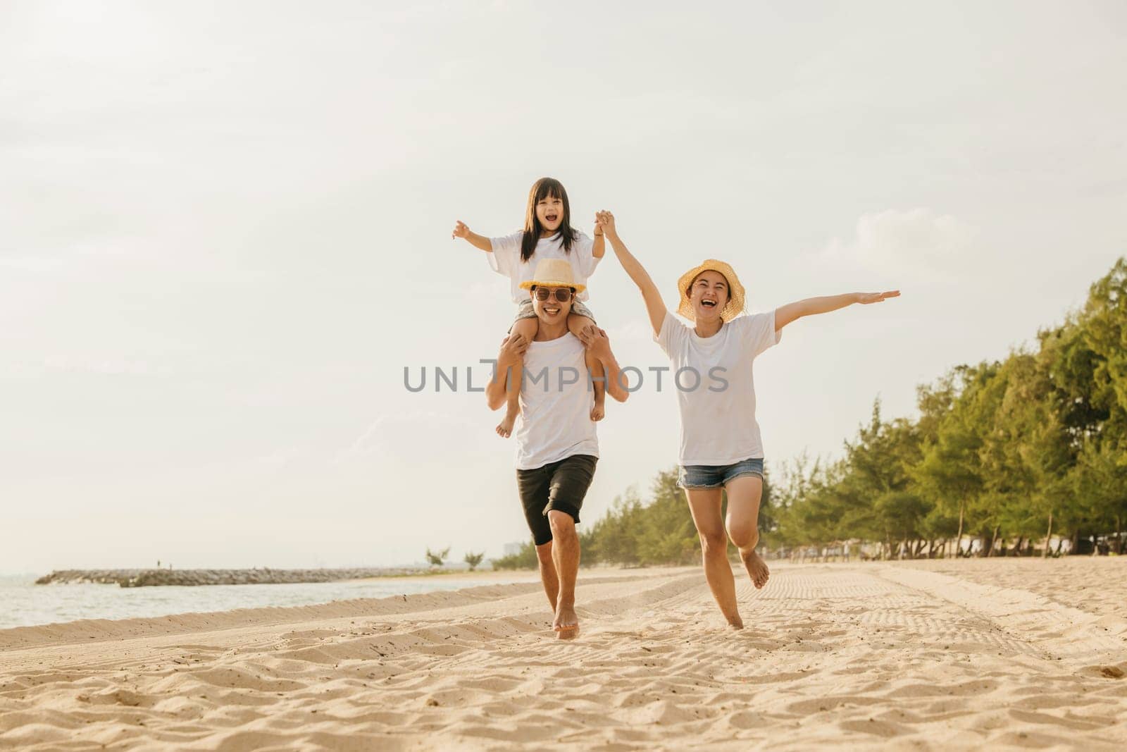 Happy family people having fun in summer vacation on beach by Sorapop