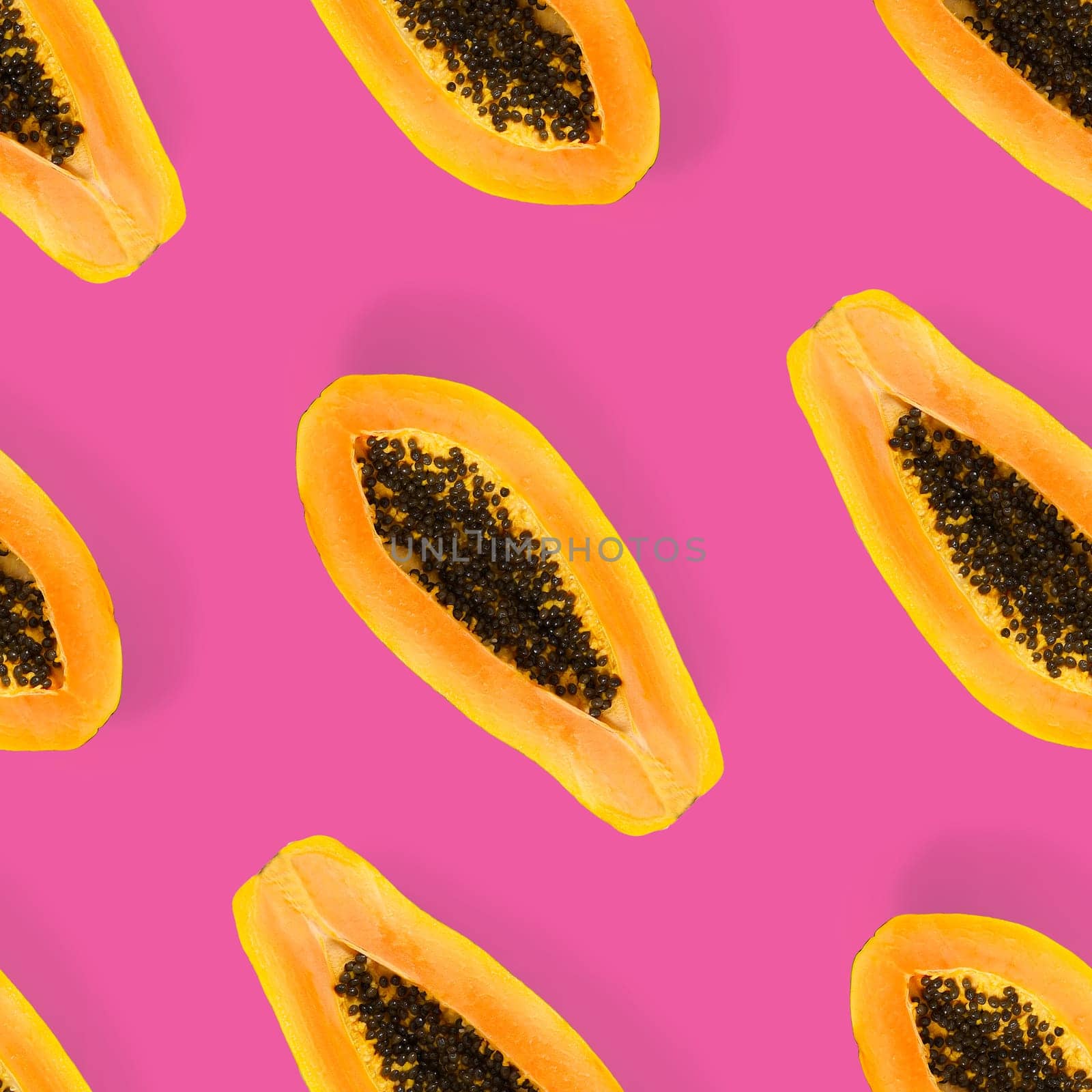 Fresh ripe papaya seamless pattern on pink background. Tropical abstract background. Top view. Creative design, minimal flat lay concept. Trend tropical fruit food background pattern