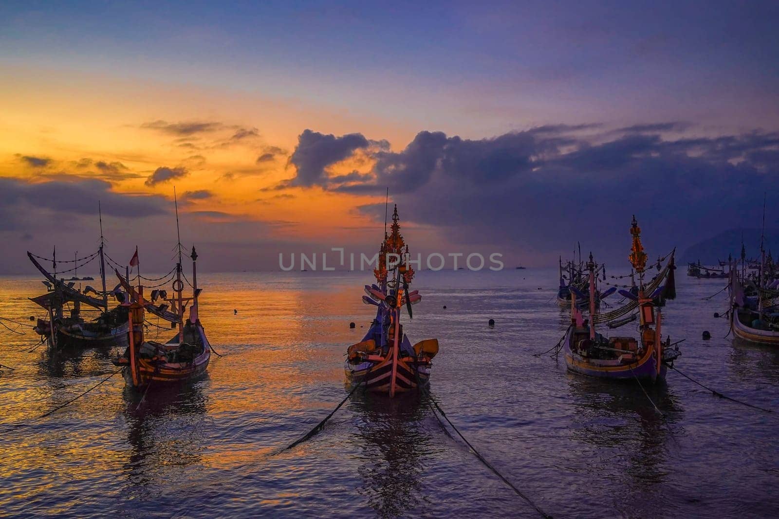 Shaky boats in long exposure photography : Moored boats during sunrise in Satelit Beach Banyuwangi