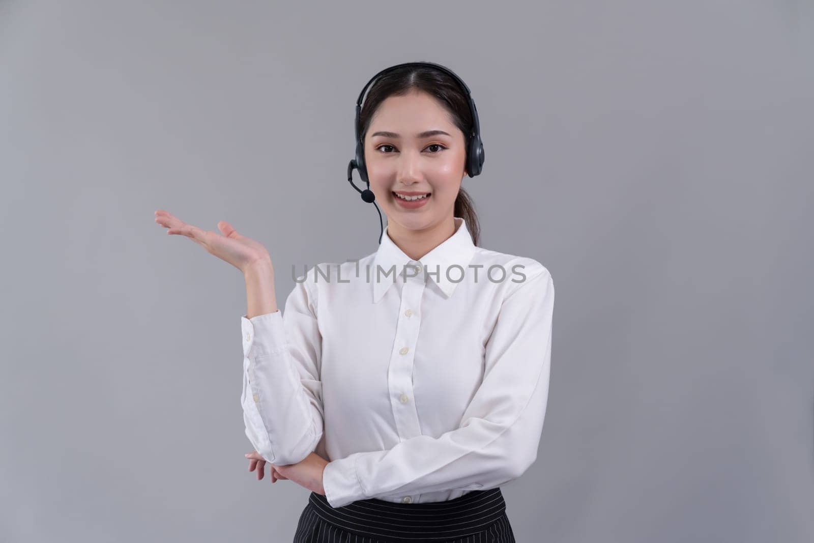 Asian operator wearing formal suit and headset with hand gesture. Enthusiastic by biancoblue