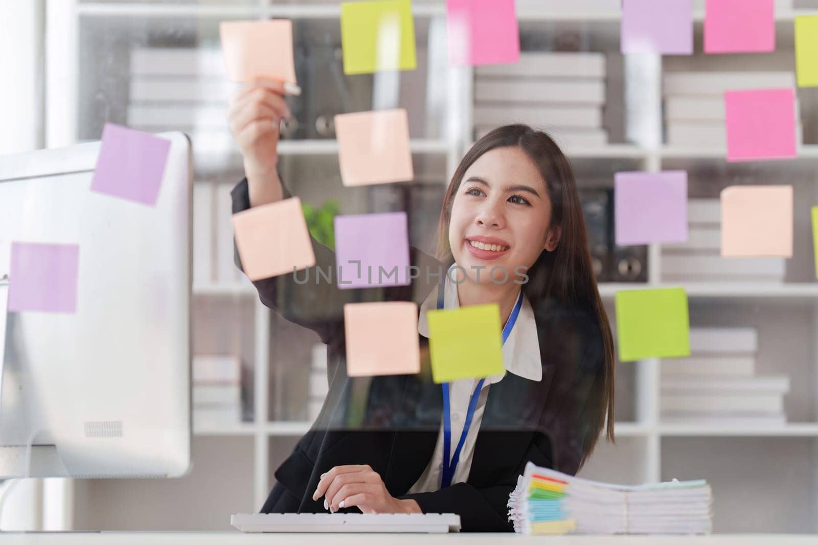 Asian Business person makes analysis and research financial report at office, analyzes profits. Accountant checks status of financial.