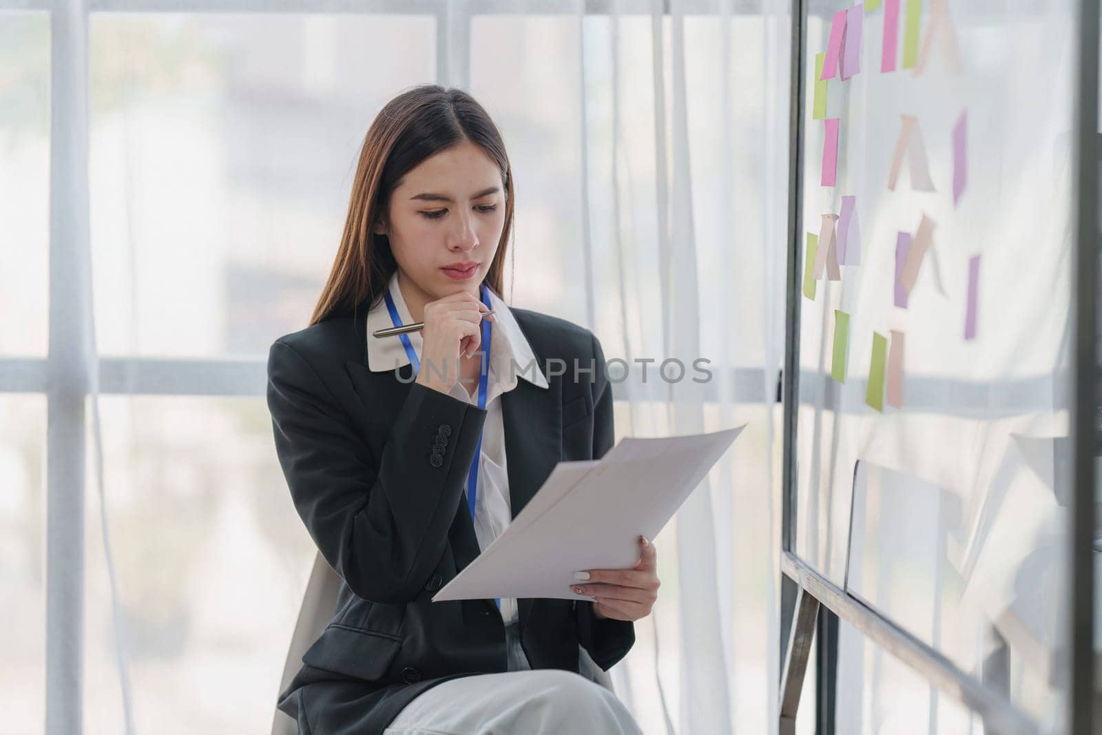 Asian Business person makes analysis and research financial report at office, analyzes profits. Accountant checks status of financial by itchaznong