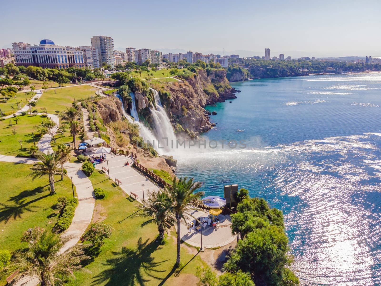 Lower Duden Falls drop off a rocky cliff falling from about 40 m into the Mediterranean Sea in amazing water clouds. Tourism and travel destination photo in Antalya, Turkey. Turkiye. by galitskaya