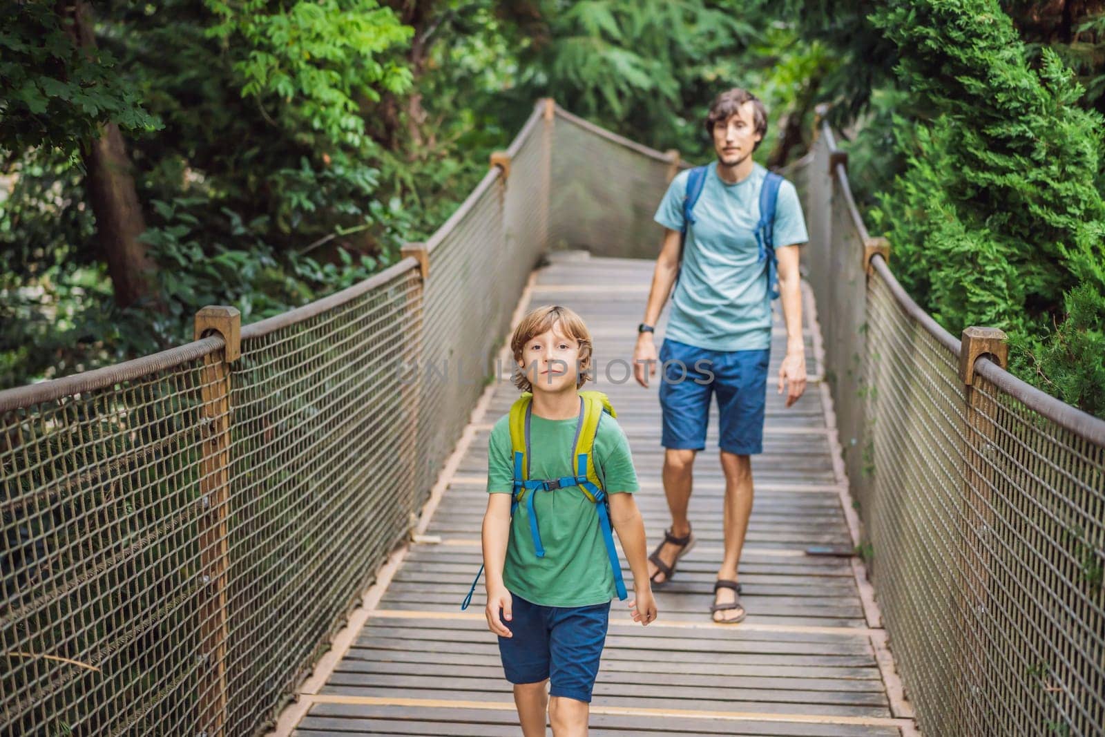 father and son tourists in Rope bridge in Yildiz Park. Besiktas, Istanbul, Turkey. Turkiye. Traveling with kids concept.