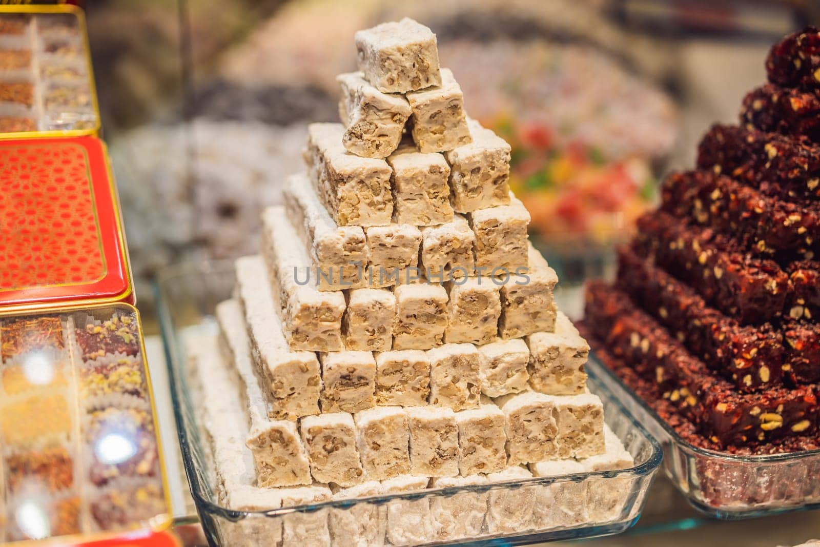 Traditional oriental sweet pastry cookies, nuts, dried fruits, pastilles, marmalade, Turkish desert with sugar, honey and pistachio, in display at a street food market.