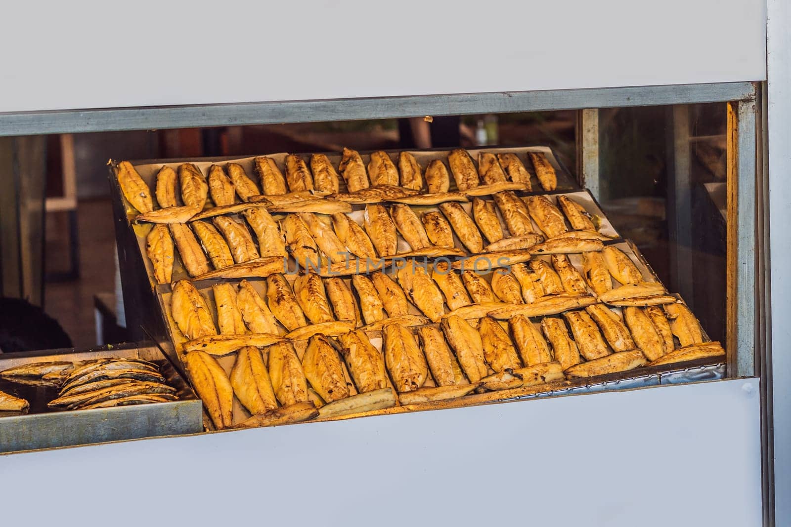 The Best Street Food in Istanbul. Preparing the famous Balik Ekmek or Fish Sandwich at a restaurant on the Galata Bridge in Istanbul, Turkey by galitskaya