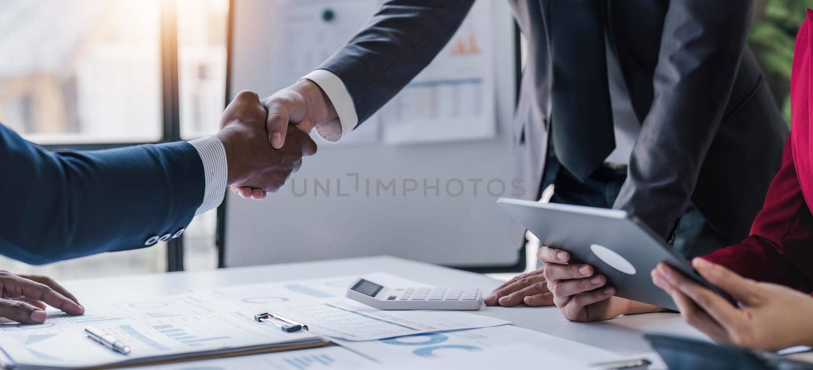 Business handshake for teamwork of business merger and acquisition,successful negotiate,hand shake,two businessman shake hand with partner to celebration partnership and business deal concept. by wichayada