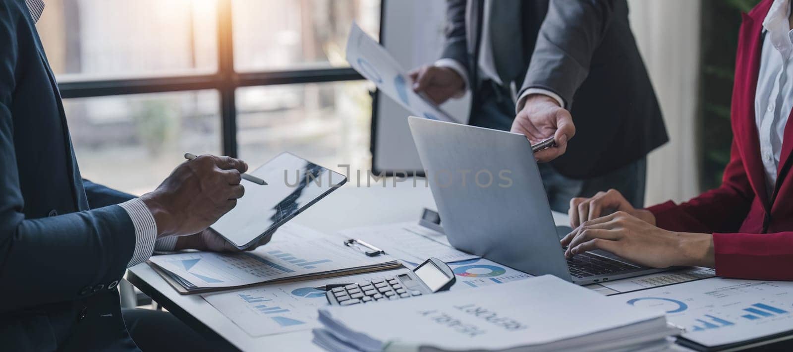 Business People Meeting using laptop computer,calculator,notebook,stock market chart paper for analysis Plans to improve quality next month. Conference Discussion Corporate Concept.