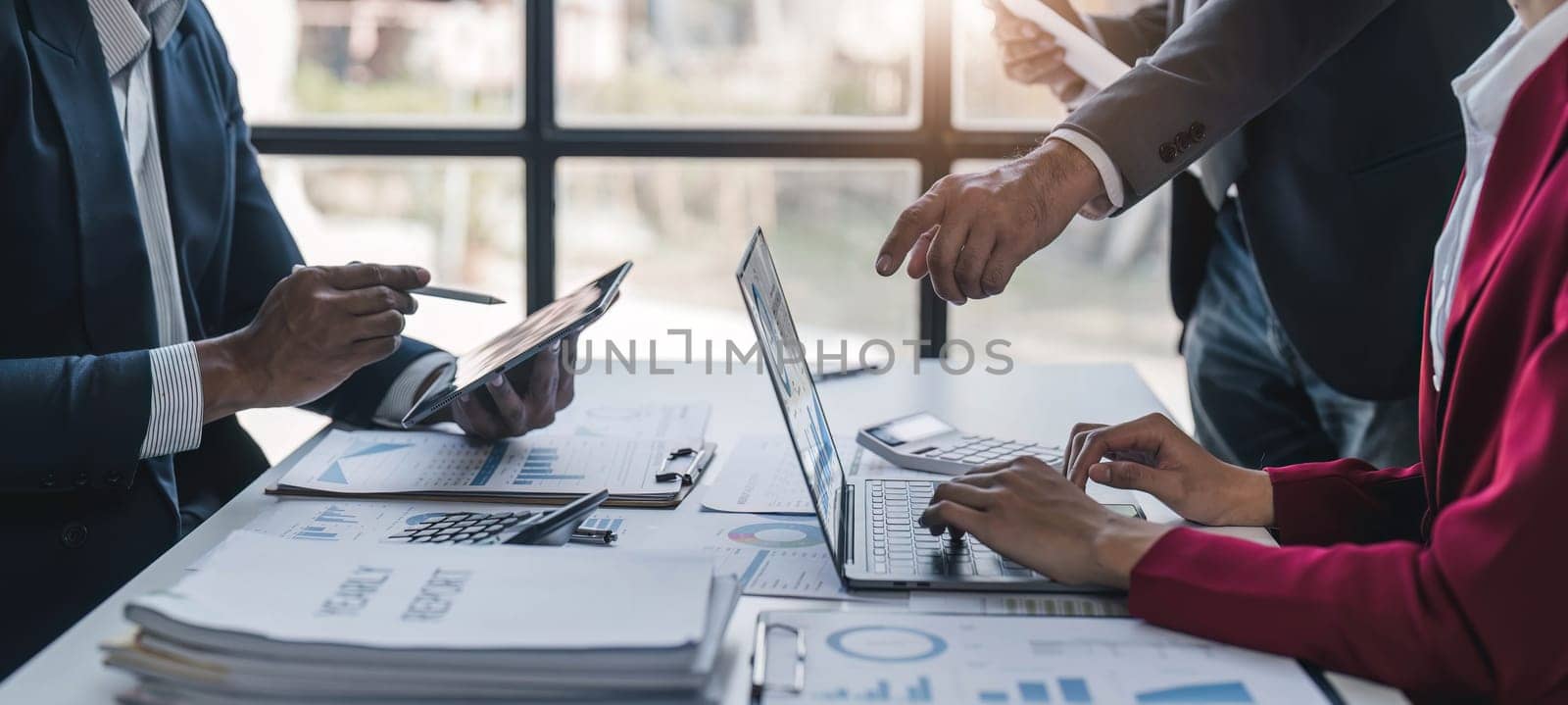 Business People Meeting using laptop computer,calculator,notebook,stock market chart paper for analysis Plans to improve quality next month. Conference Discussion Corporate Concept.