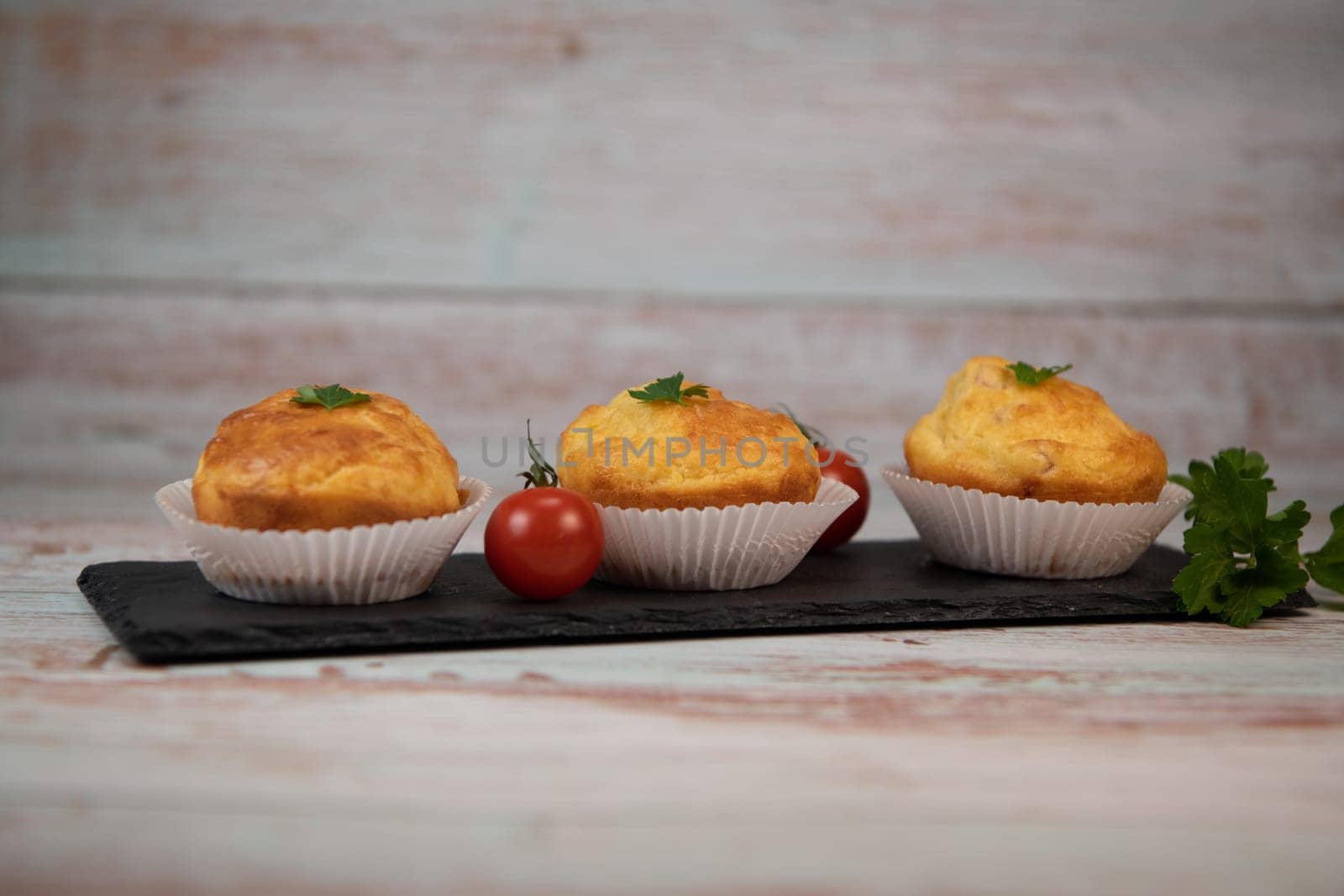 Savory muffin with ham and cheese on blue background, High quality photo