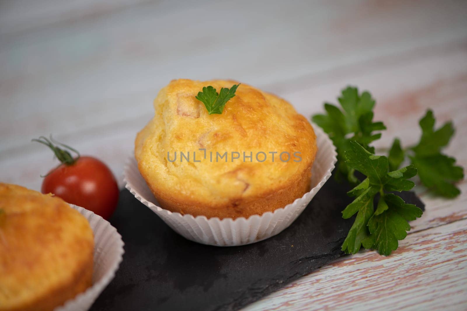 Savory muffin with ham and cheese on blue background, High quality photo