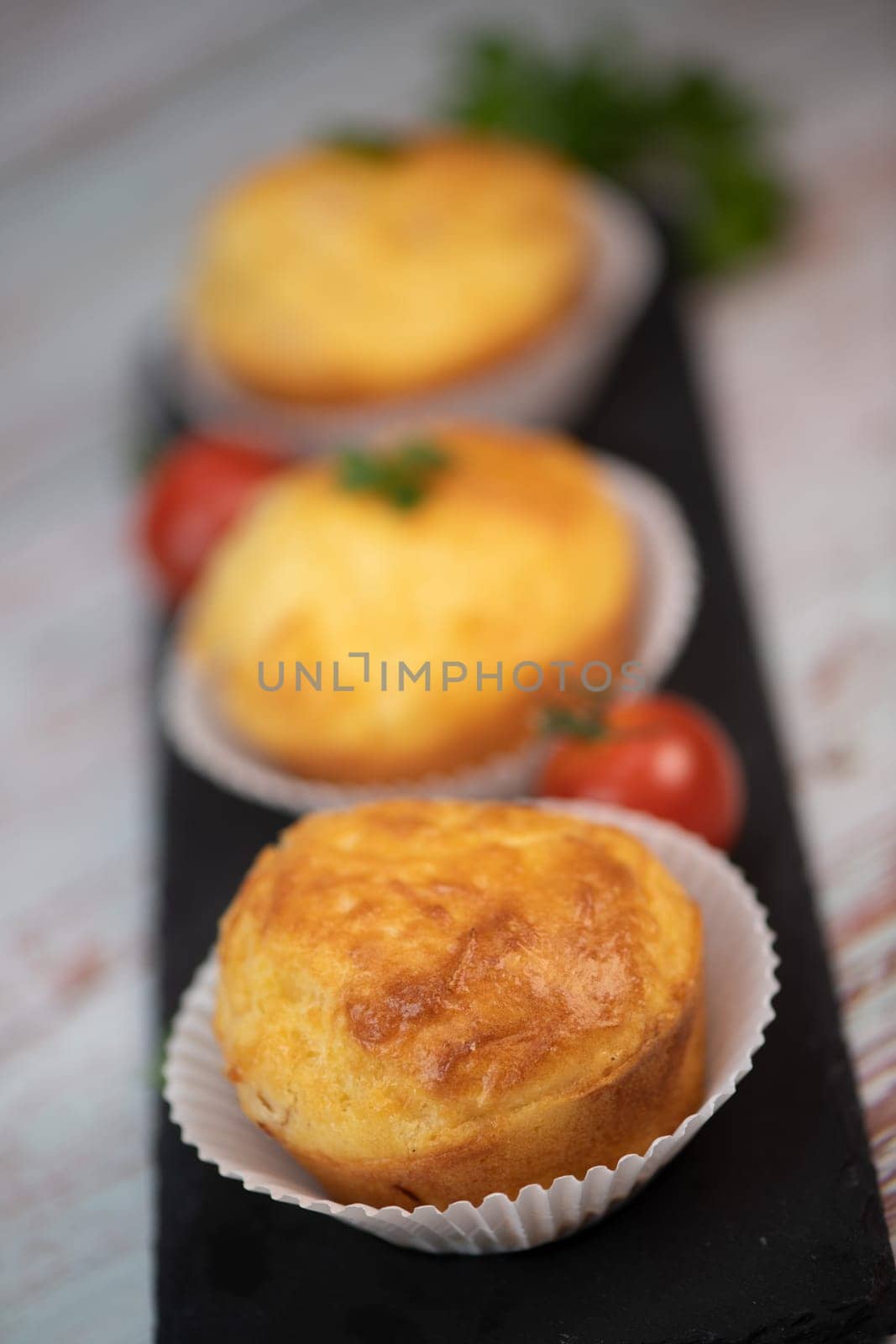 Savory muffin with ham and cheese on blue background, High quality photo