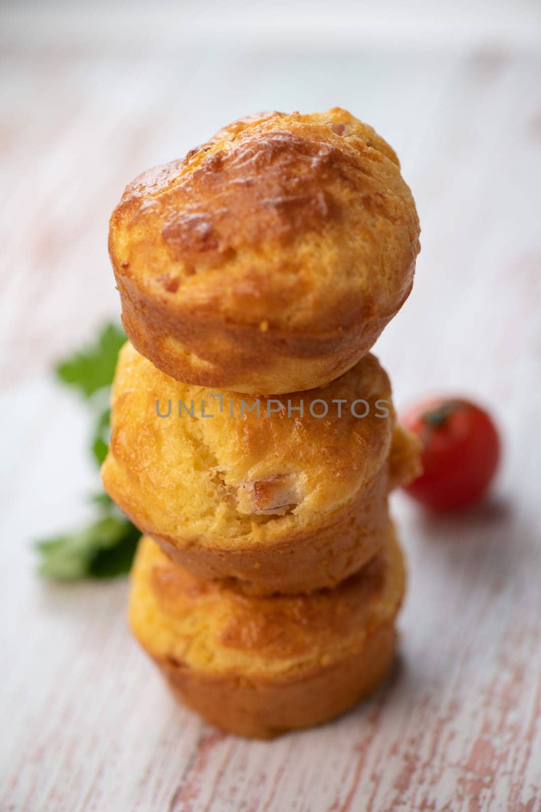 Savory muffin with ham and cheese on blue background, High quality photo