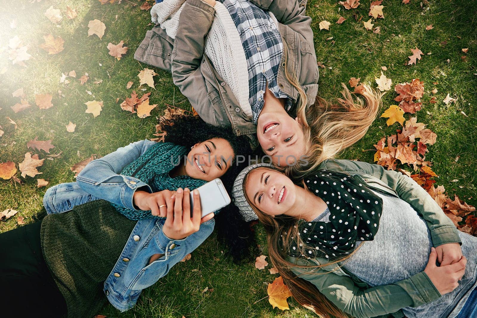 Check out this cool video I found. High angle shot of three happy teenagers relaxing together on the grass outside
