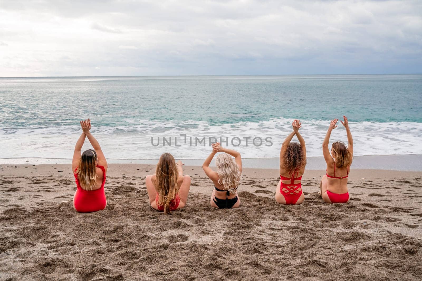 Big happy family or group of five friends is having fun against sunset beach. Beach holidays concept. by Matiunina