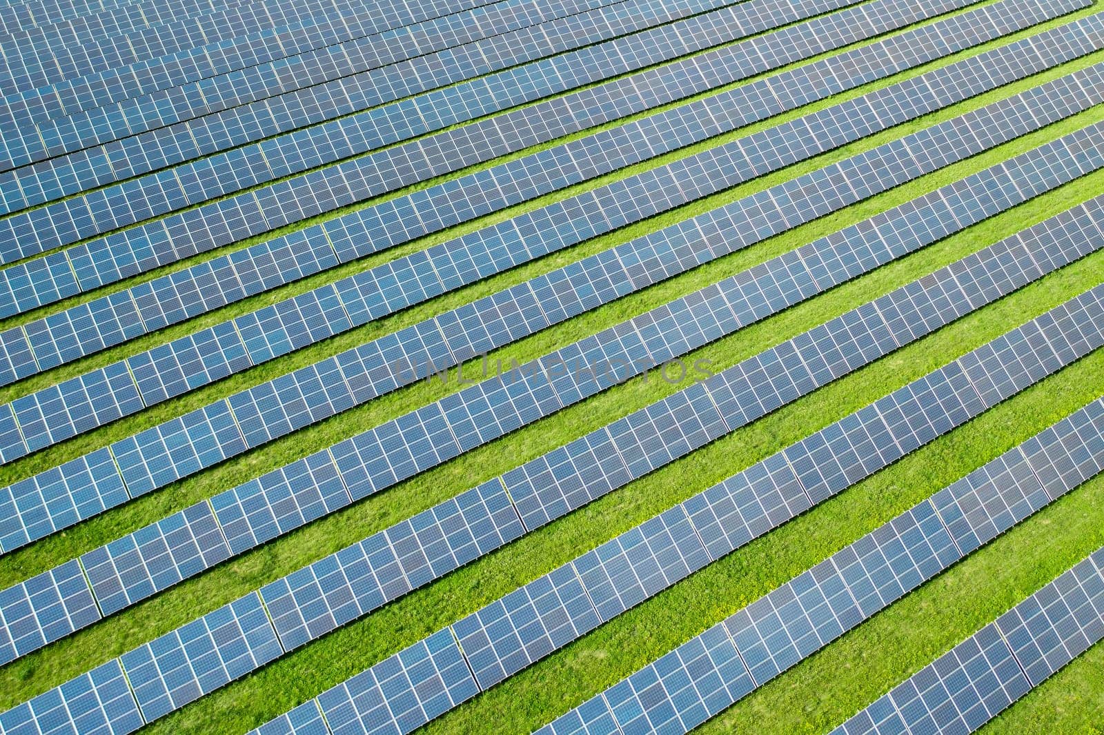 Aerial view of a solar panel for green energy production in a field. Cheap electricity or increasing of price on electricity resources concept