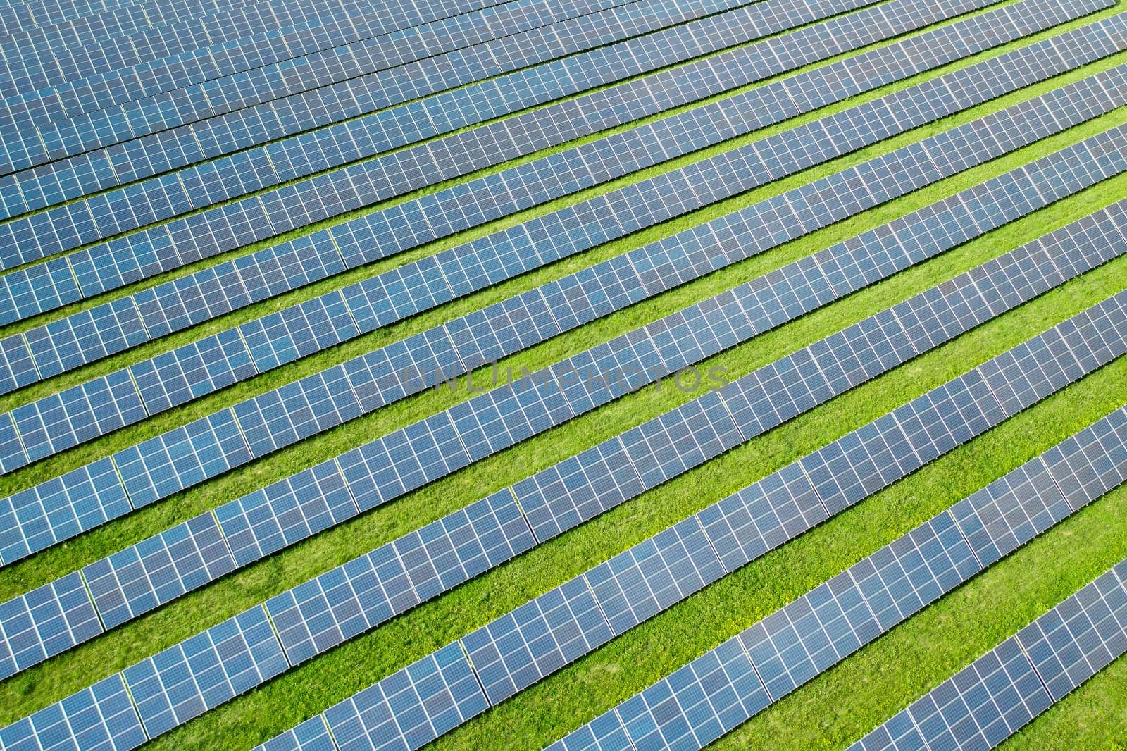 Aerial view of a solar panel for green energy production in a field. Cheap electricity or increasing of price on electricity resources concept