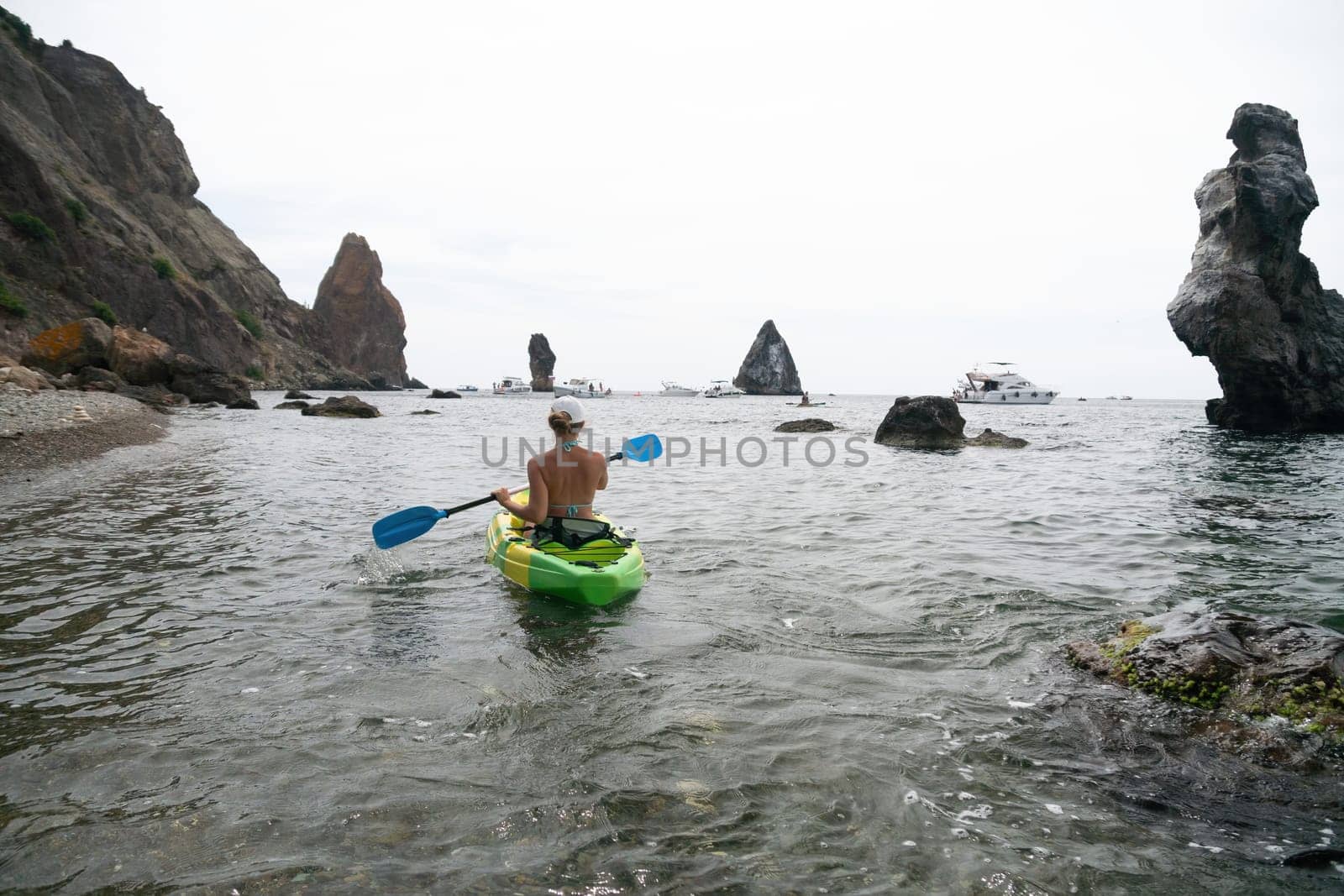 Kayaking. Travel adventure kayak on the tropical sea on a sunny day. Woman rowing a canoe.