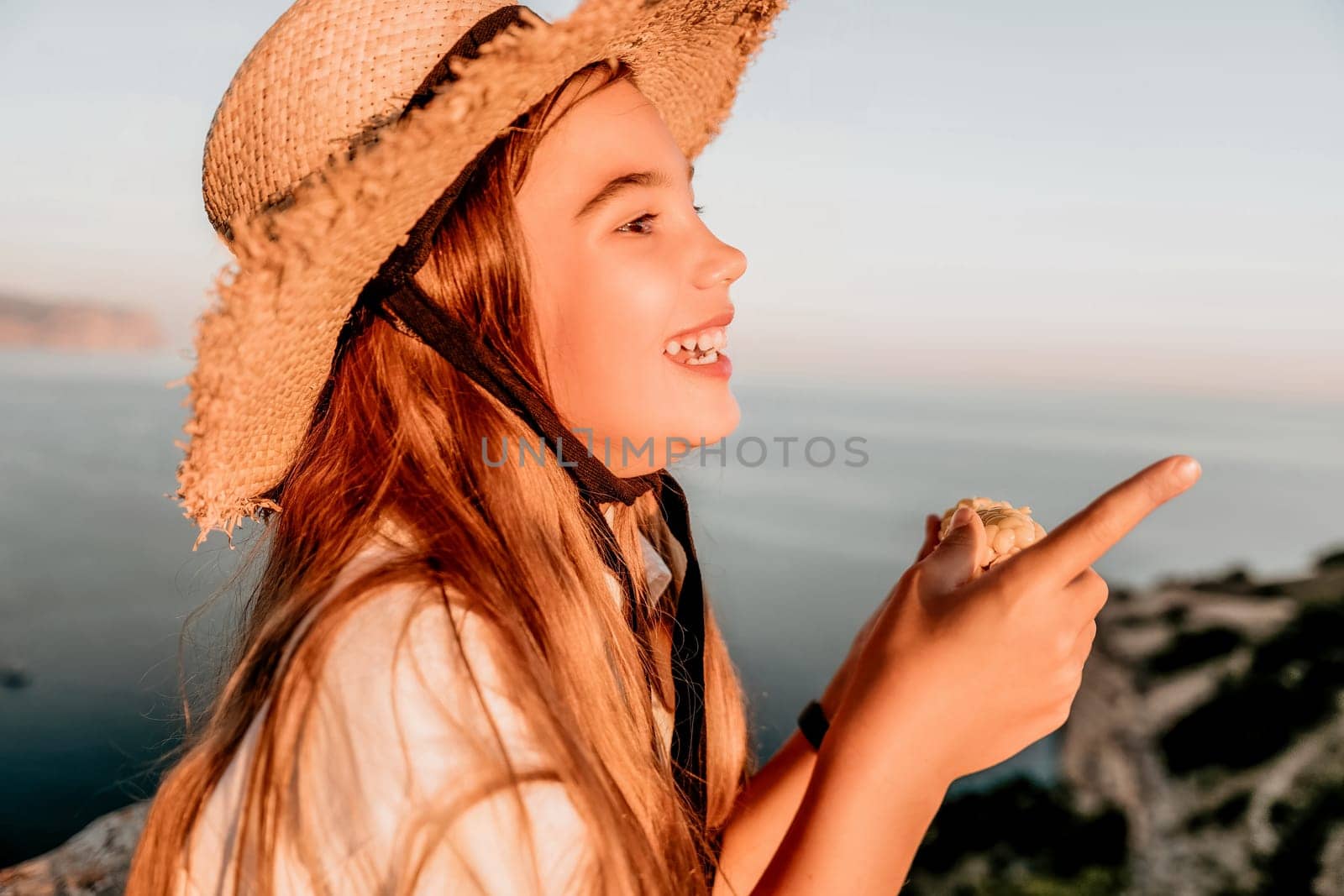 Portrait of young beautiful girl eating corn. Snacking on the sea