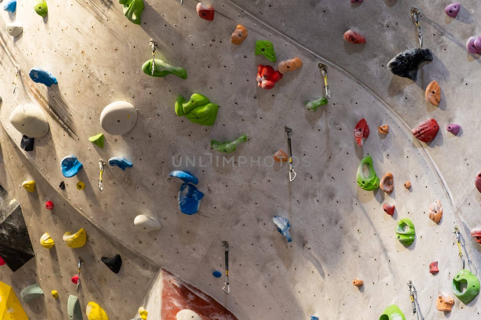 Artificial rock climbing wall with various colored grips.